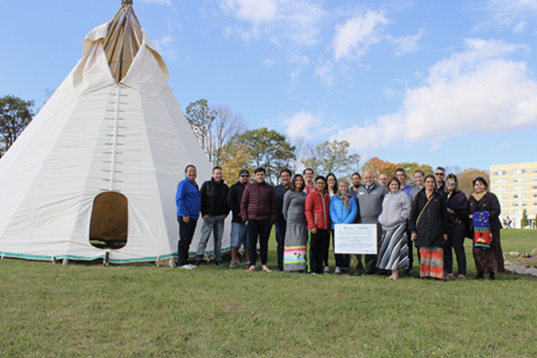 group of people standing beside Lakehead tipi
