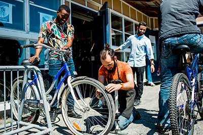 A student checking tire pressure as part of a LUSU bicycle event