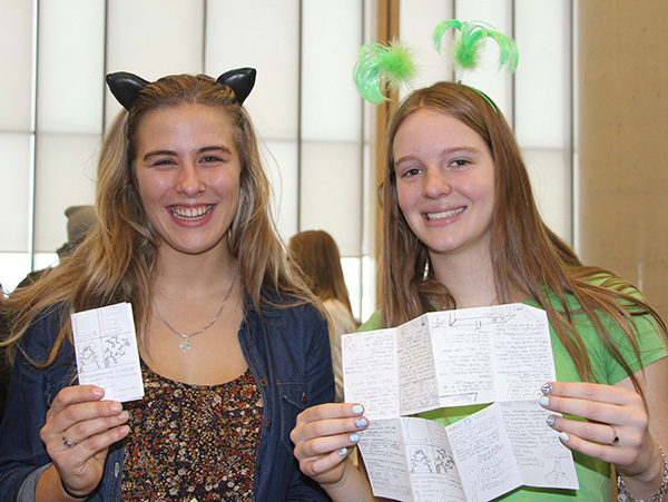 Lakehead students Hailey Mulhall and Julie Puckering present a "zine" that was created (using one sheet of paper) to provide information about the University's environmental practices for a unique class project that resulted in a “protestival.”