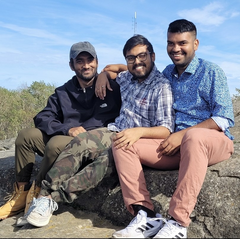 International students Mohammad, Souvik, and Abu sitting outside