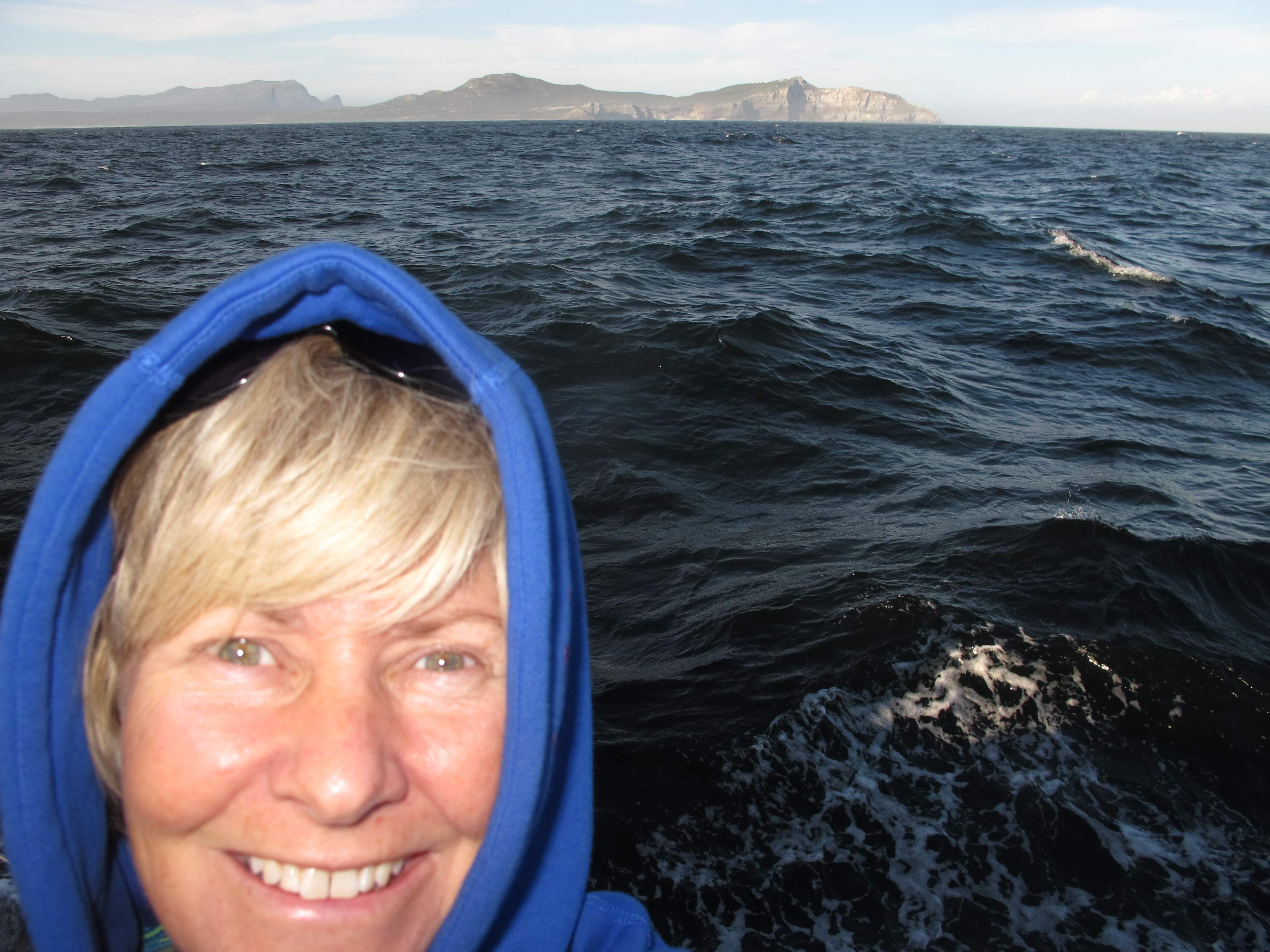 Jennifer wearing a hoody sailing around the Cape of Good Hope