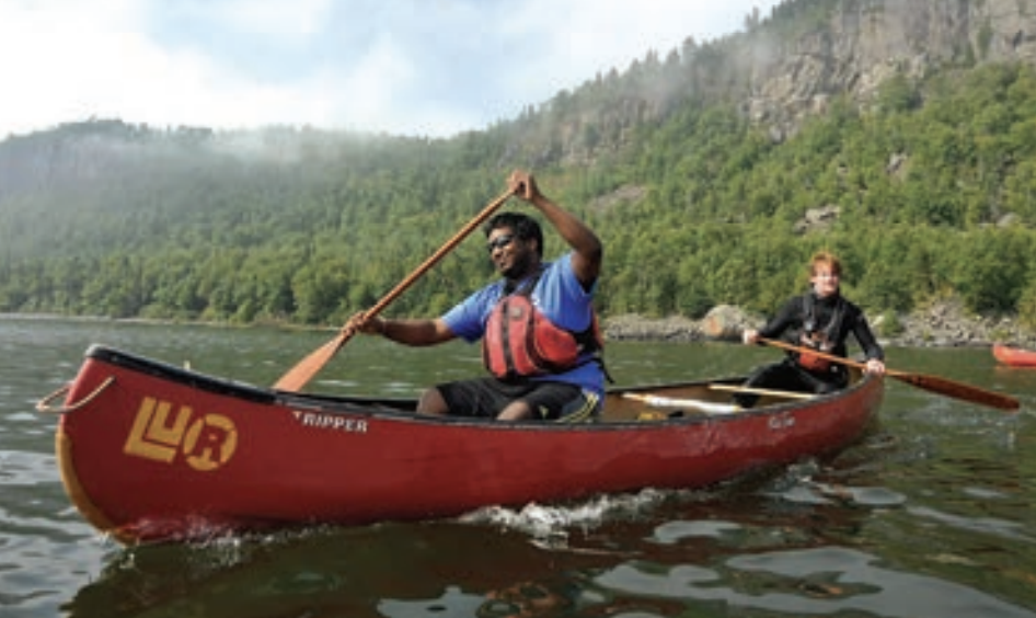 Two students in a red canoe