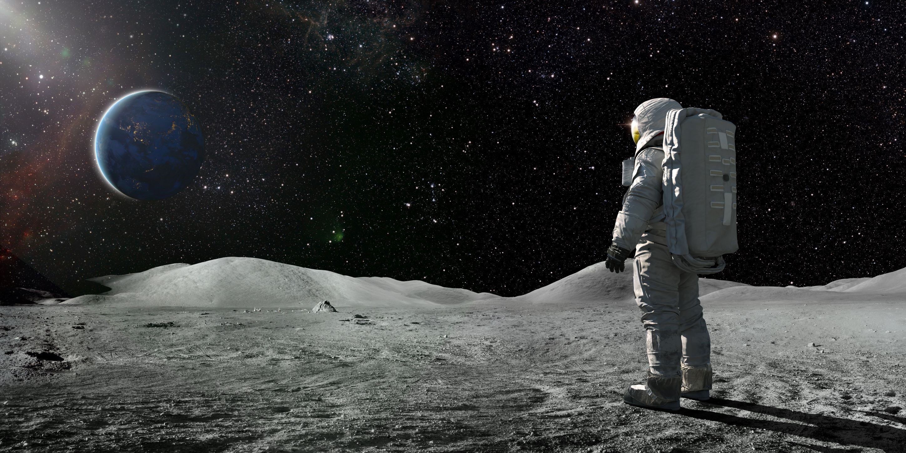 Photo of an astronaut on the Moon, looking back at Earth.