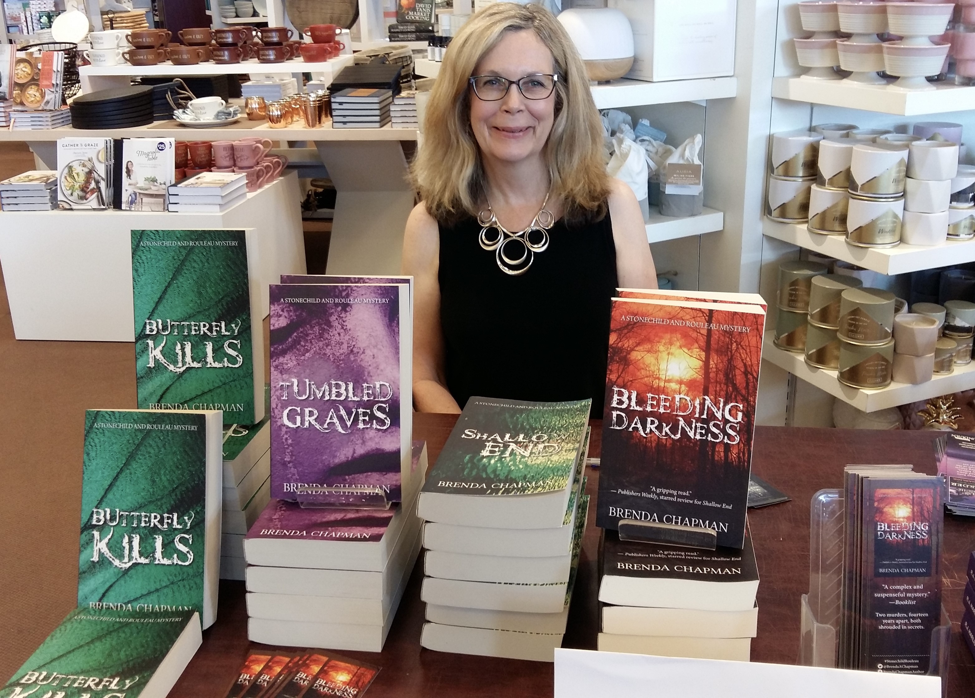 Author Brenda Chapman sits a table displaying her books