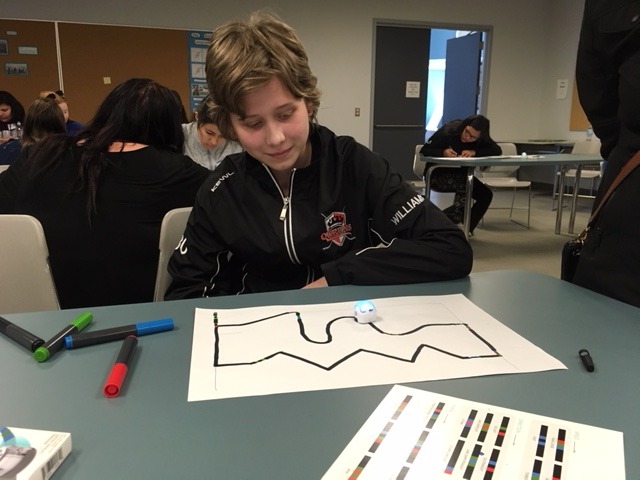 Camryn Williams watches an Ozobot create lines on paper during a Niijii Mentorship Program session in a Lakehead Thunder Bay classroom