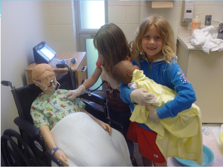 Camryn Williams and a fellow elementary student practice medical skills with mannikins in Lakehead's Nursing Simulation Lab