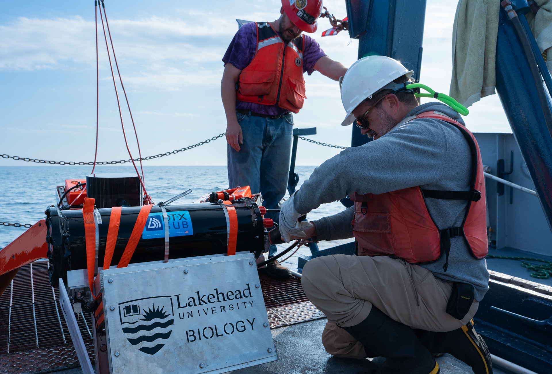 Dr. Michael Rennie helps prepare the submersible on the deck of the Blue Heron