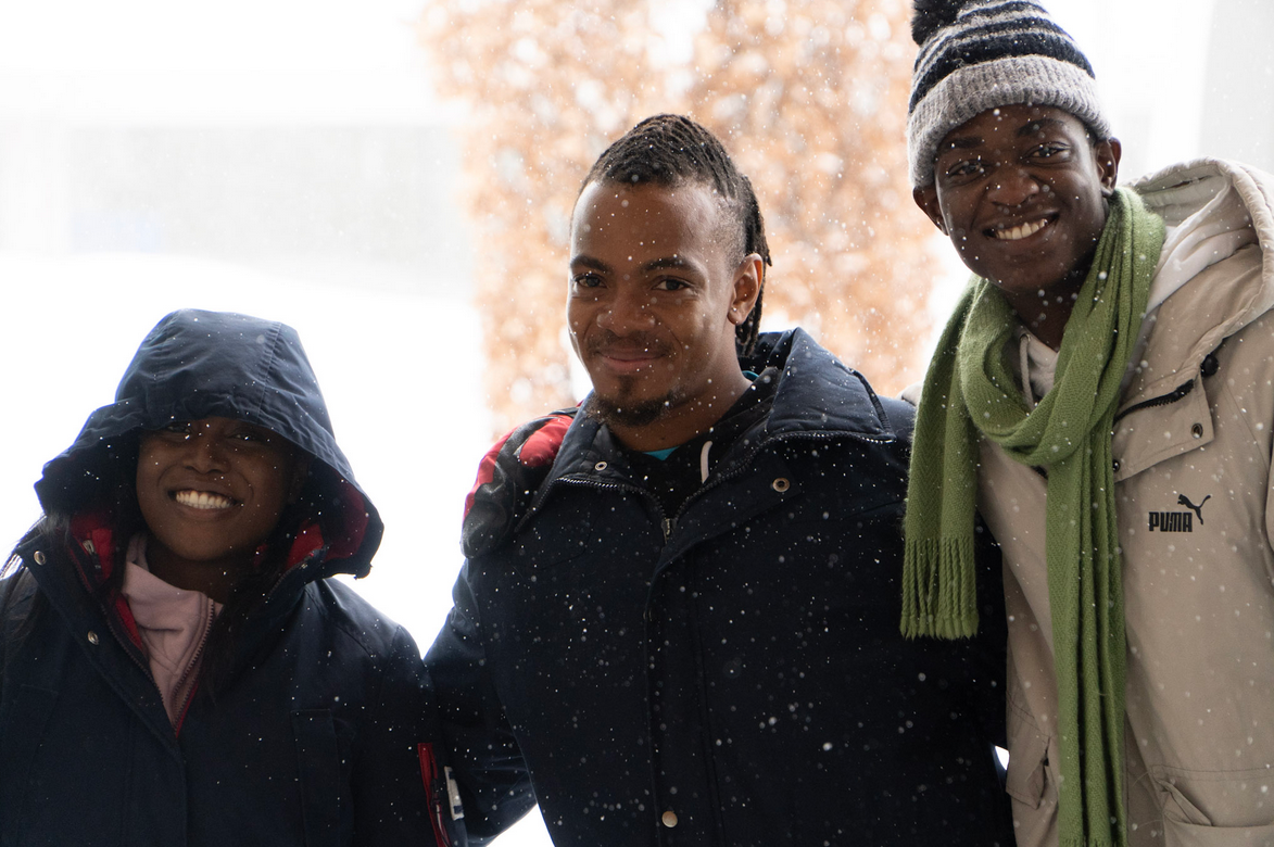 Three Students in Falling Snow Three students standing outside in the falling snow during the 2025 Global Citizen Summit