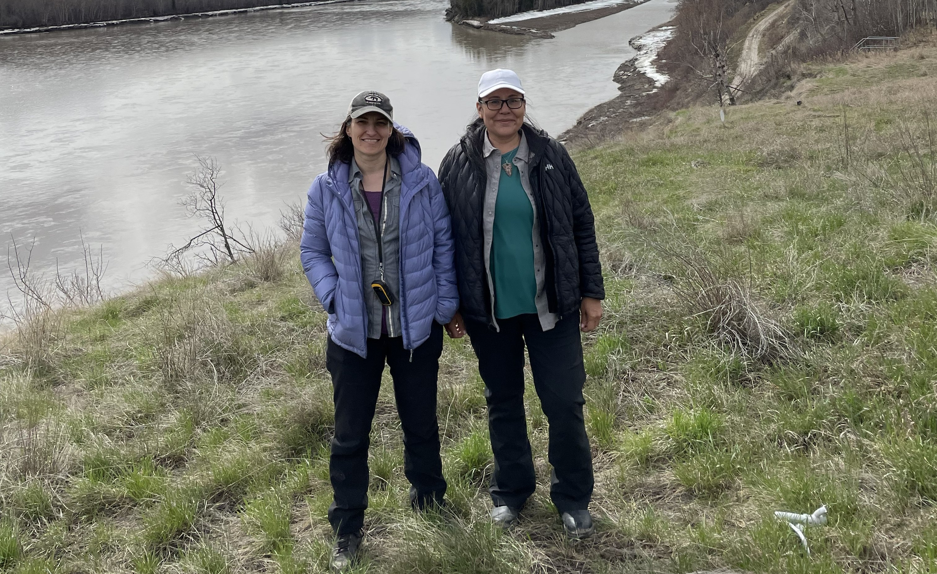 Jessica Metcalfe & Victoria Wanihadie Two women stand beside a river
