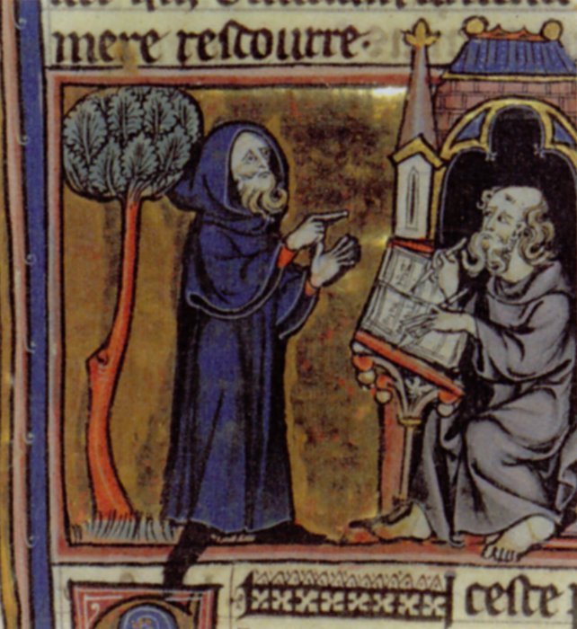 A medieval illustration of Merlin, wearing a blue robe, points a finger towards a seated monk writing in a book