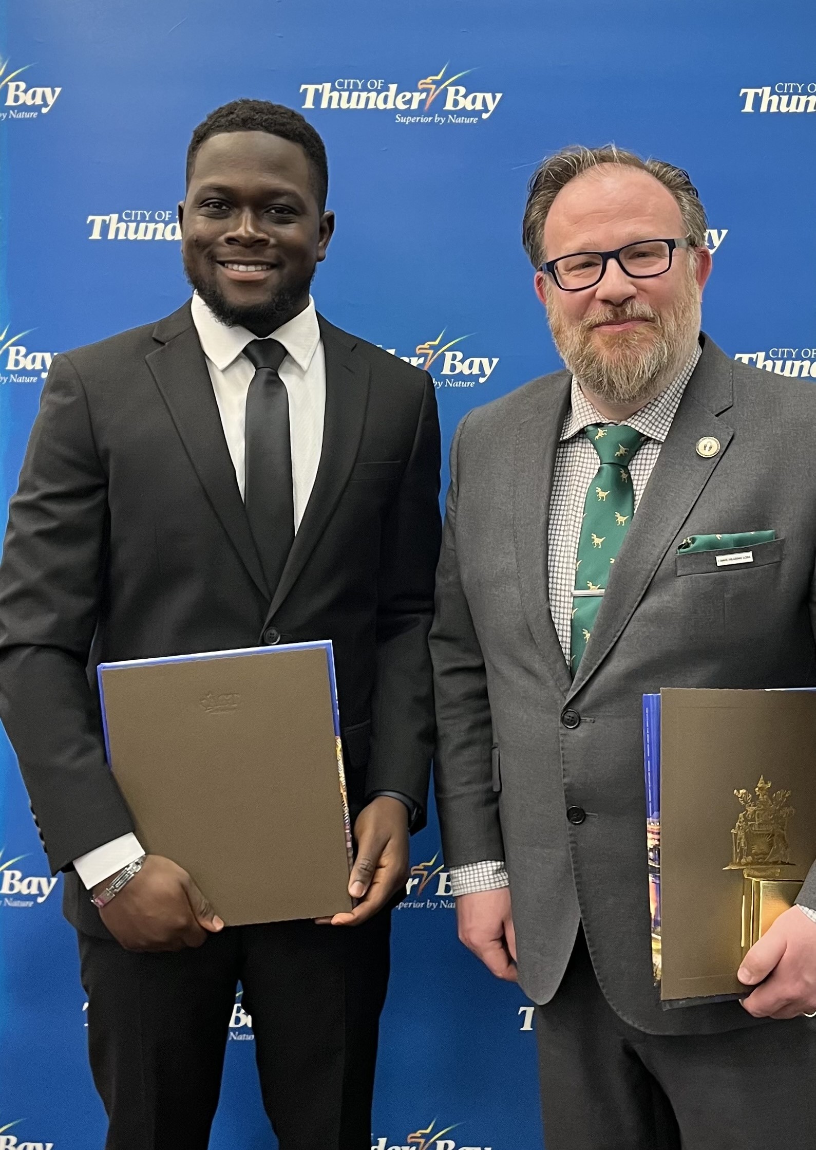 Temitope Ojo stands beside Dr. Michel S. Beaulieu after receiving a Good Citizenship Award from the City of Thunder Bay 
