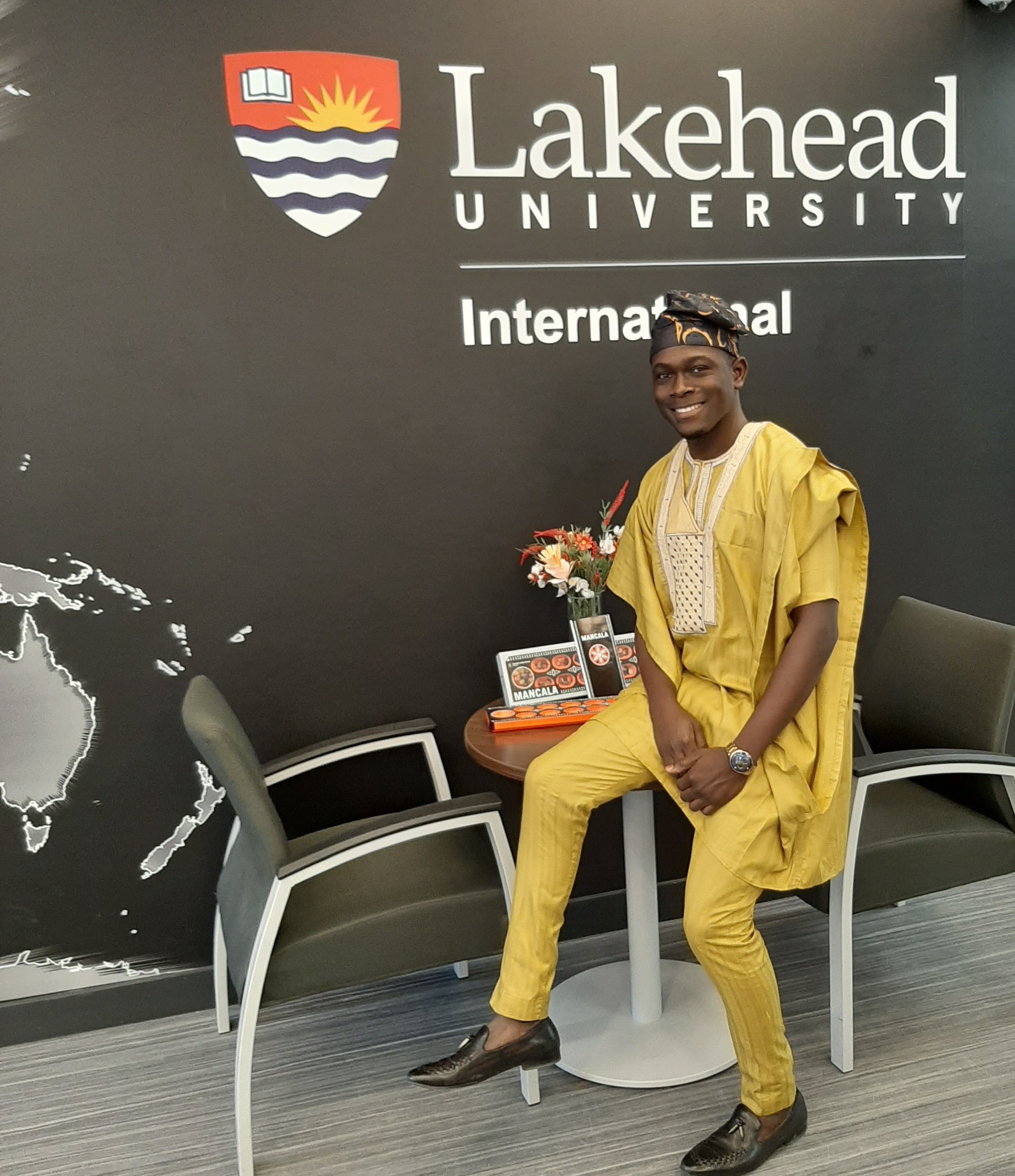Temitope Ojo sits on a table in the Lakehead International lounge