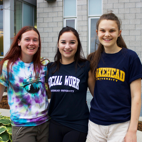 Students huddled together with their new Lakehead clothing