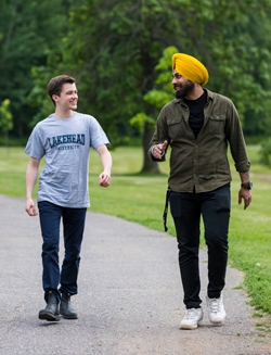 Two students walking down a path on Lakehead campus