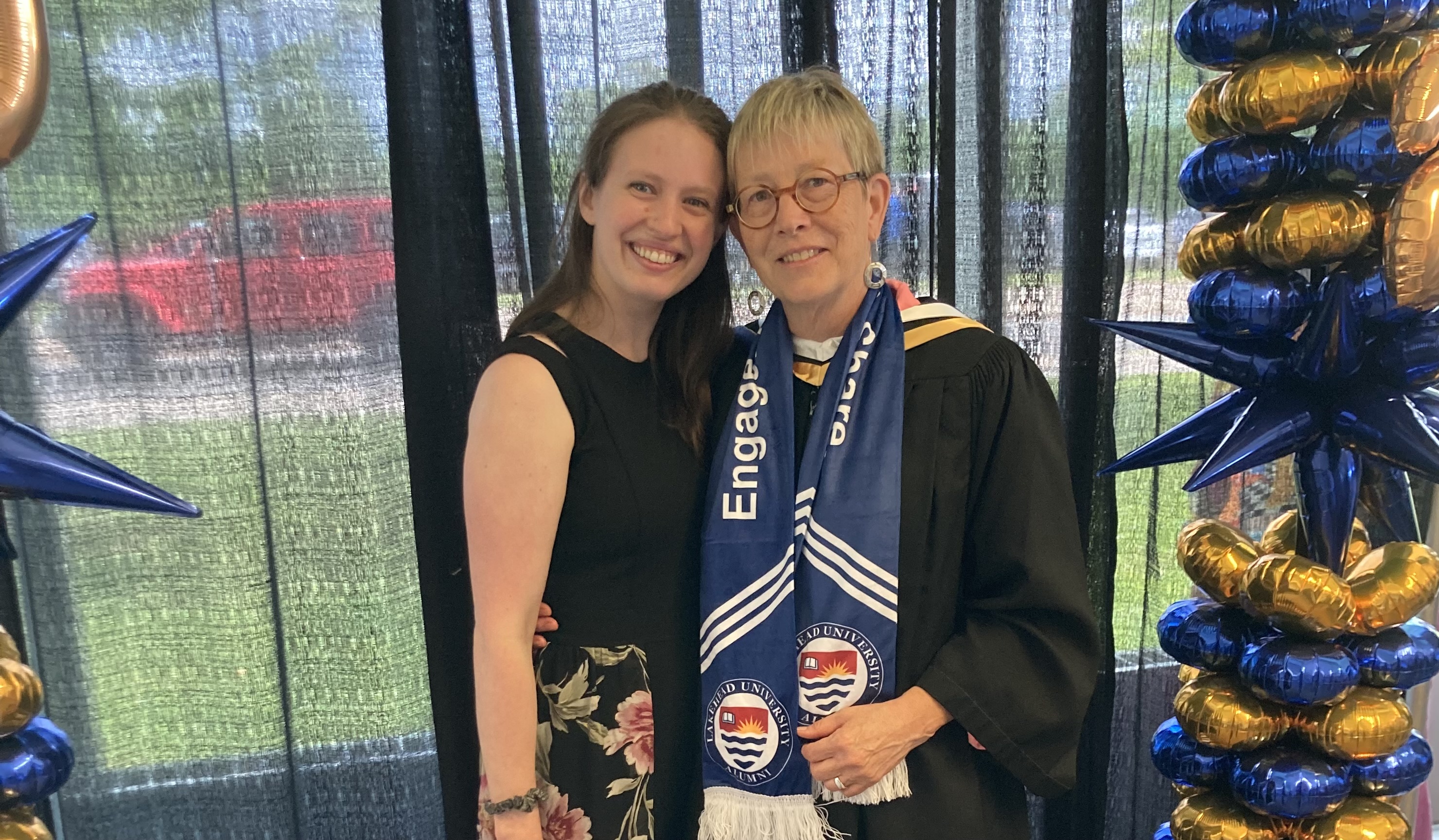 Holly and Alexandria Holly Gray wearing a convocation robe stands beside her daughter Alexandria at her 2024 convocation