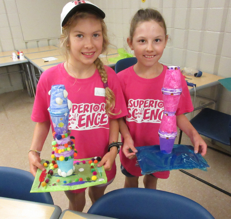 Photo of two girls holding their creations.