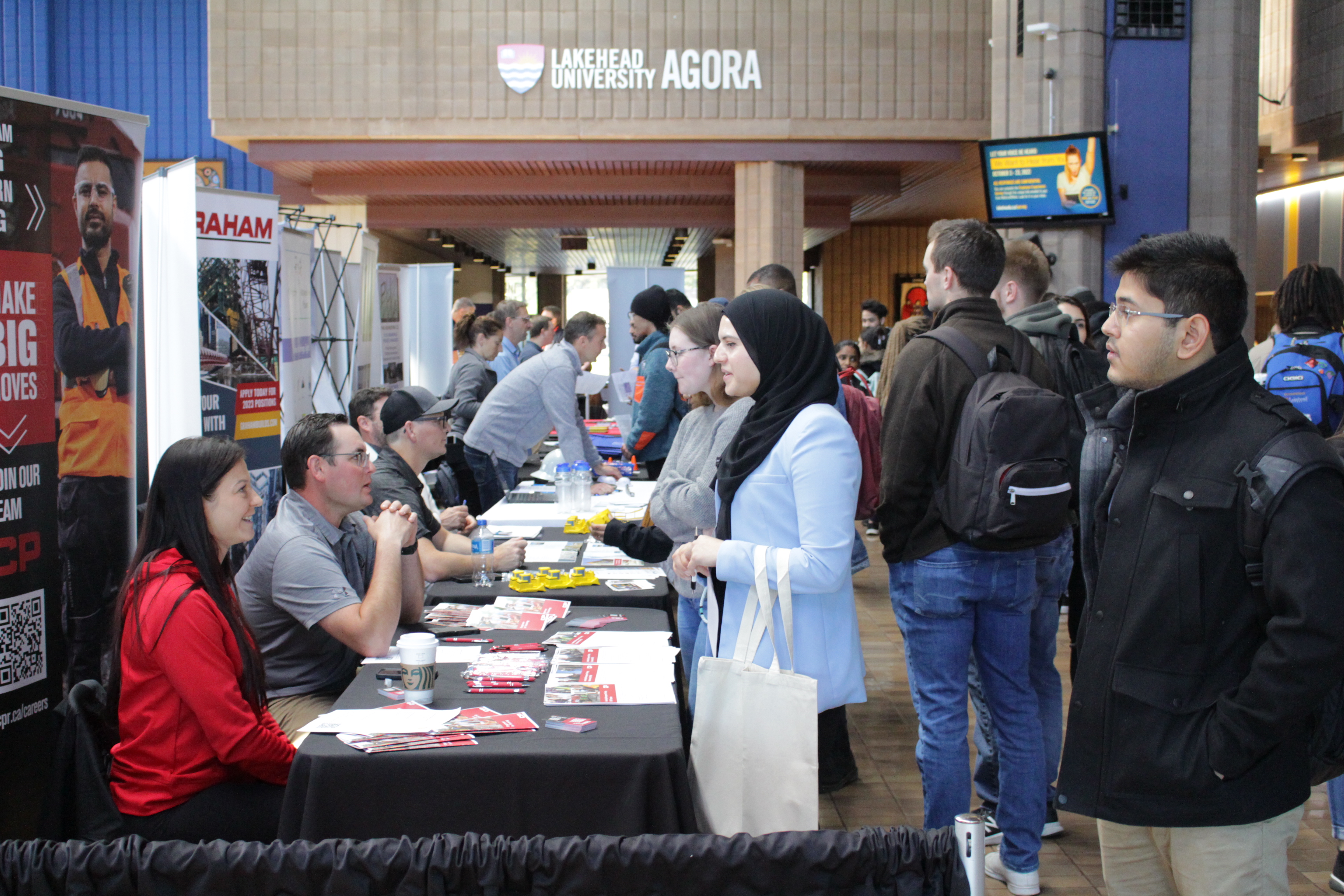 Students can be seen enjoying the career fair in the agora on Lakehead Thunder Bay's campus