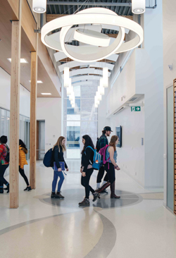 Students walking through a hallway on campus