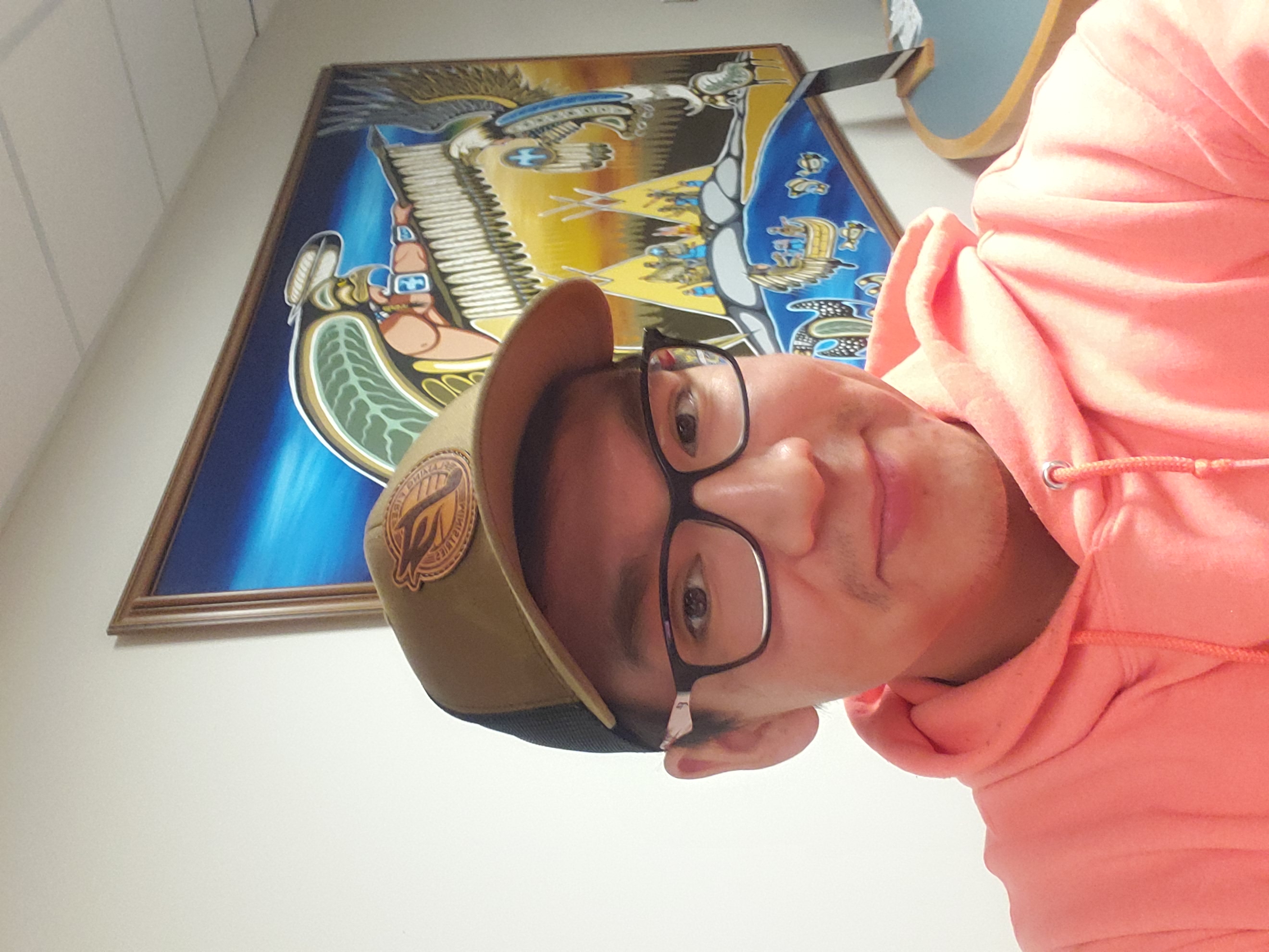 Jared Visitor Jared Visitor stands in front of a Woodland Style painting