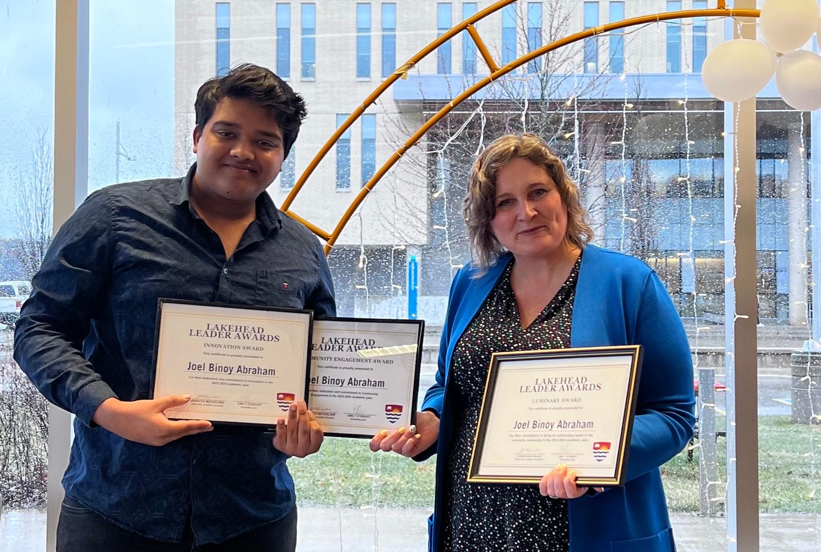 Orillia student Joel Abraham accepts three Lakehead Leader Awards from Orillia Principal Dr. Linda Rodenburg