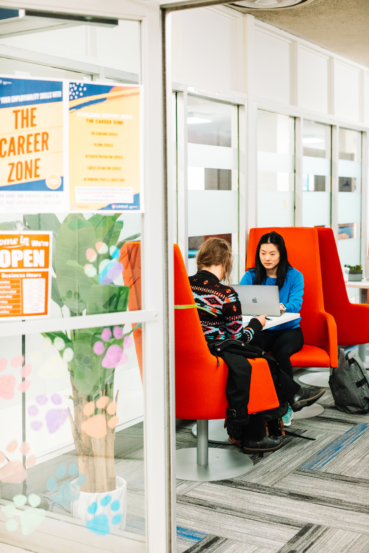 Two students sit in Lakehead University Thunder Bay's Career Zone. 