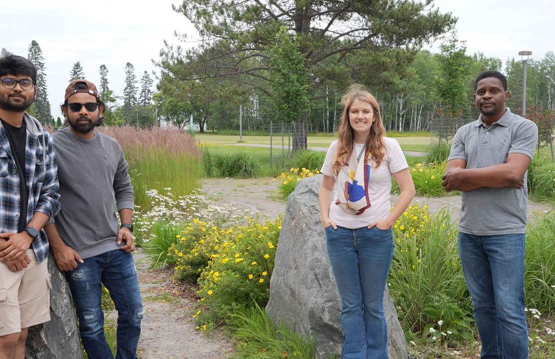 Devon Lee and Philosophy of Education students stand at the Wellness Path entrance