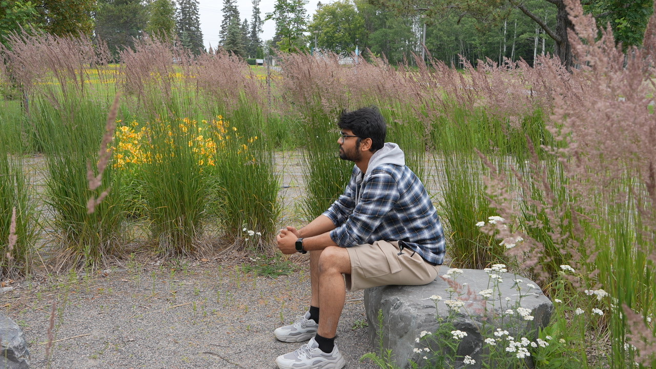 Student Arafat Alamgir Shanto sit at the centre of the Wellness Path labyrinth