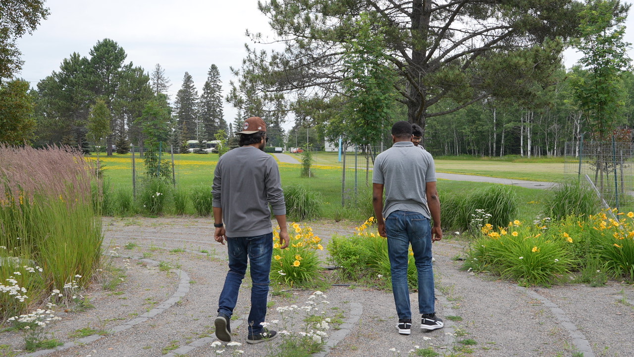 Three students walk the Wellness Path labyrinth