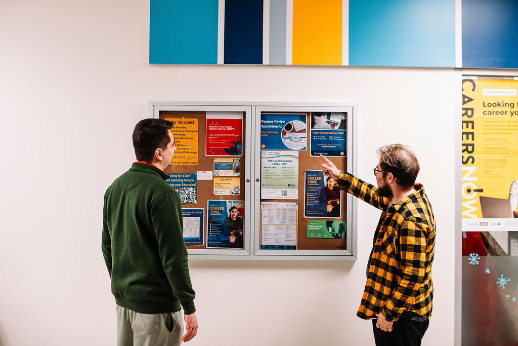 A pair of students look at the Career Zone bulletin board on the Thunder Bay Campus