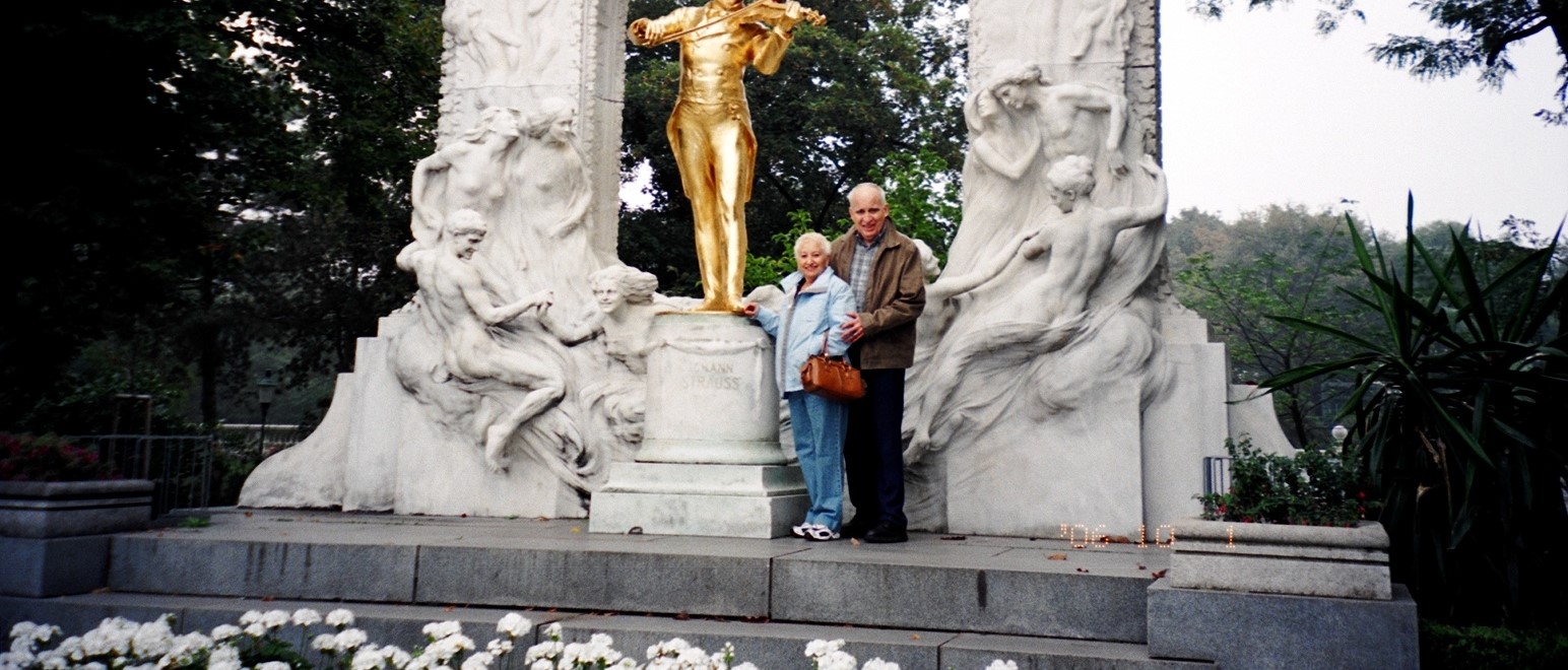 Barb and Lynn Barber stand beneath an arch in Vienna on a Sound of Music tour