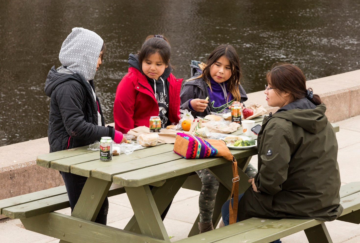 Picnic Lunch Children in the Achievement Program having lunch at a picnic table on Thunder Bay campus