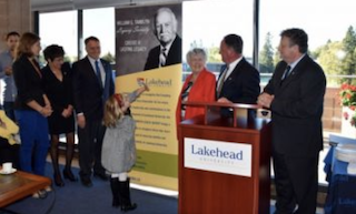 Members of the Tamblyn family pose for a picture with Lakehead University President, Dr. Brian Stevenson