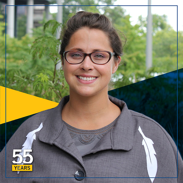 Stephanie Seymour standing in front of the beautiful campus foliage with Lakehead University branding