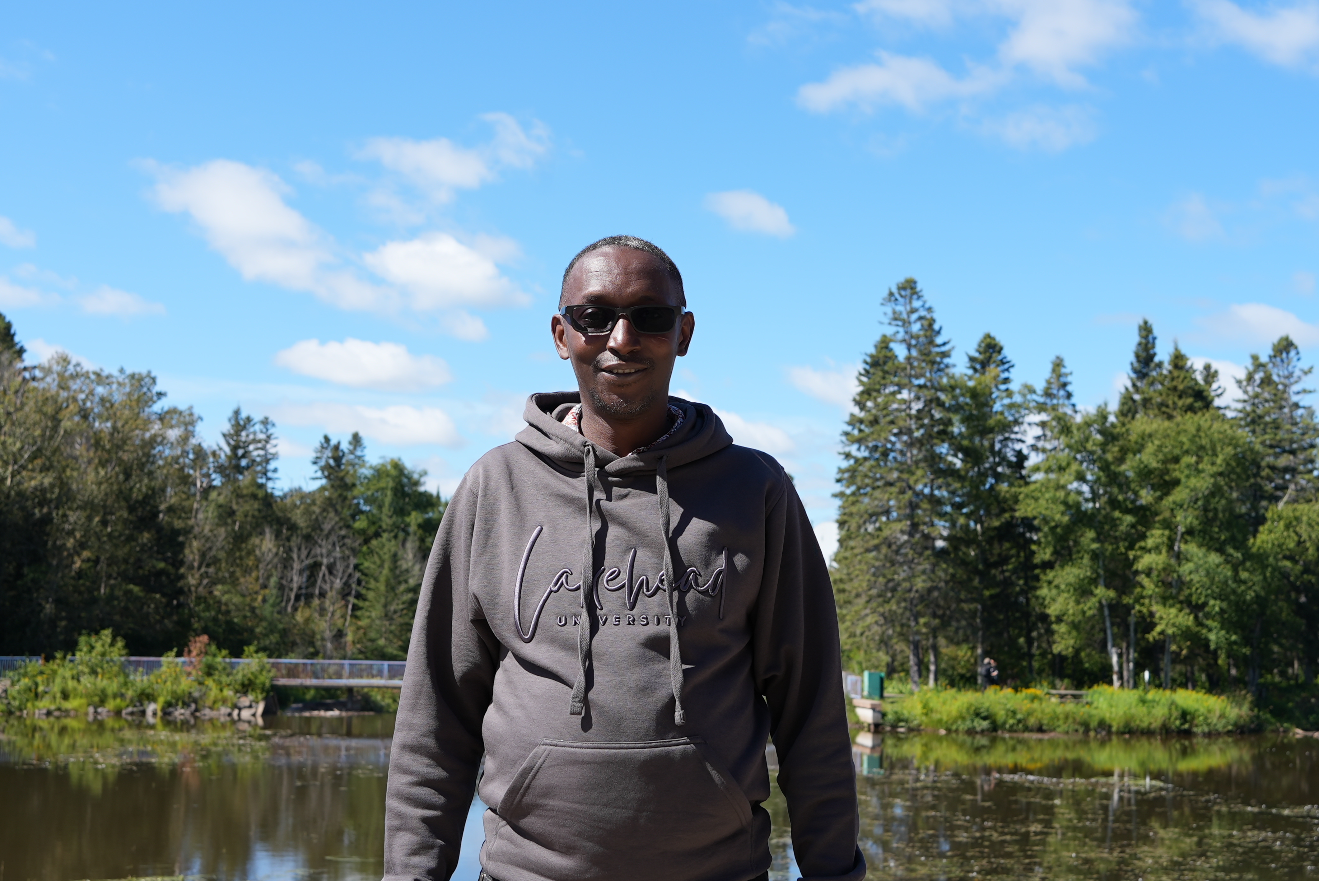 First-year student Anthony Wagaki stands in front of Lake Tamblyn