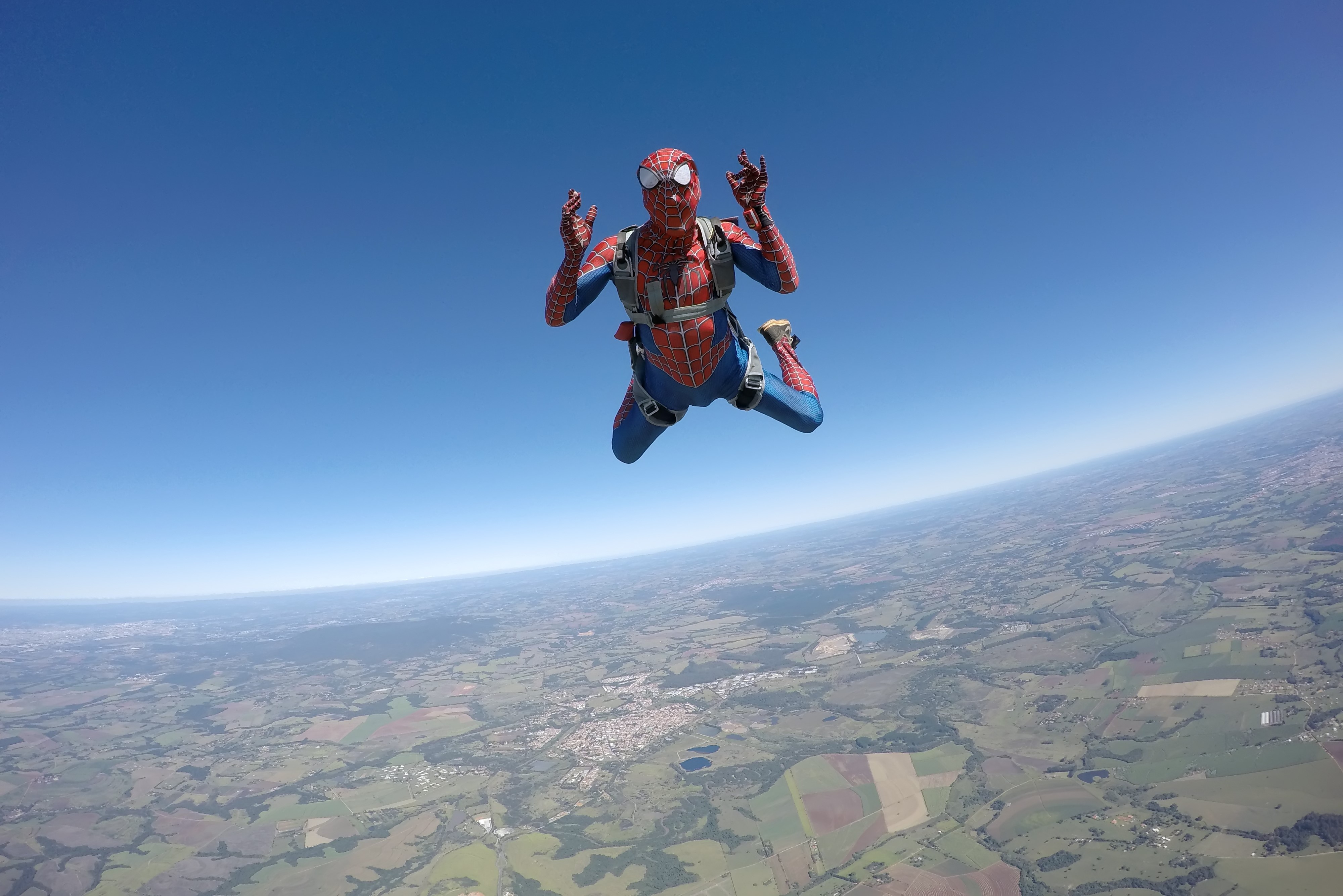 Man parachuting dressed in Spiderman costume