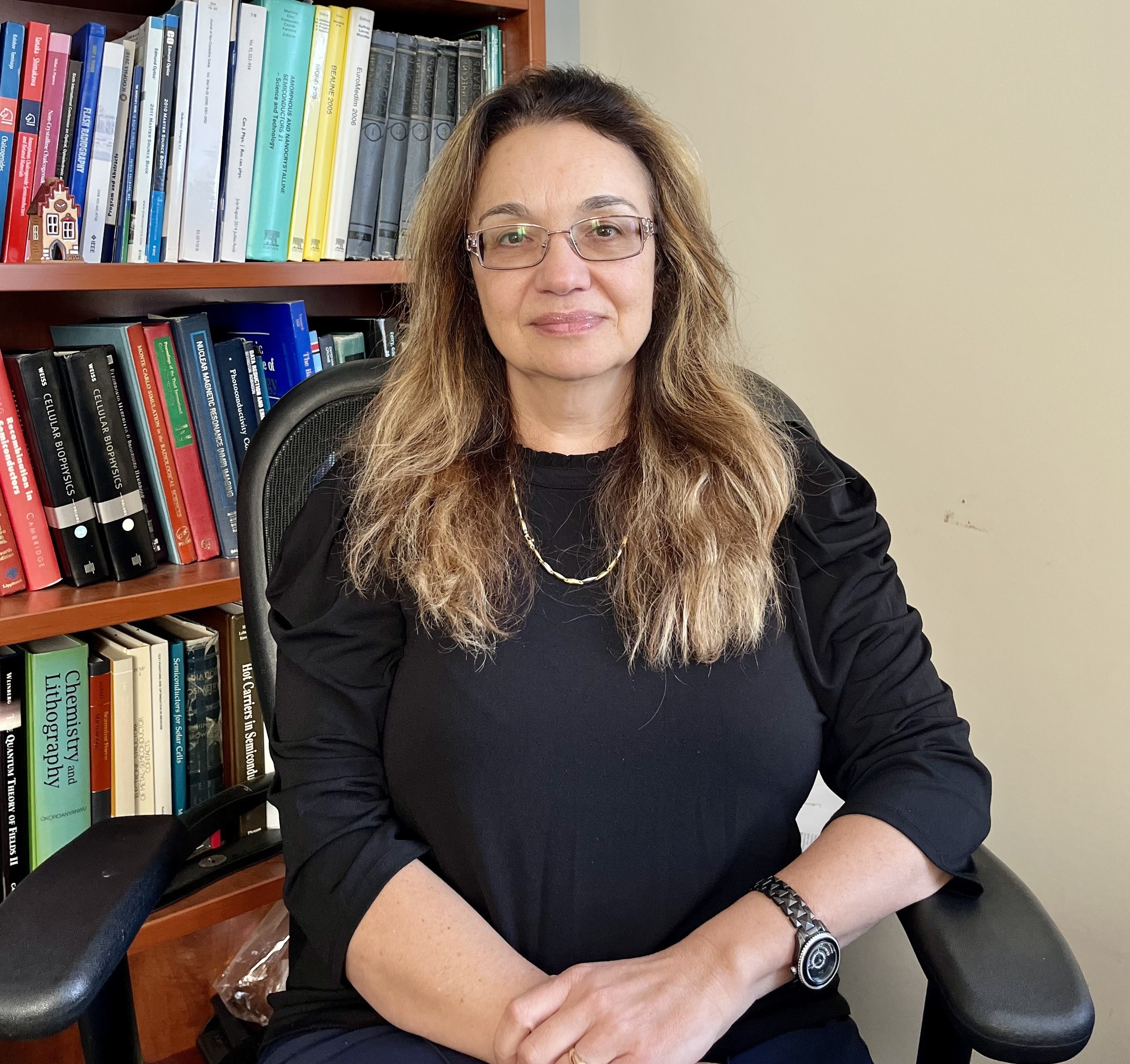 Dr. Alla Reznik Dr. Alla Reznik sits in an office chair in front of a bookcase