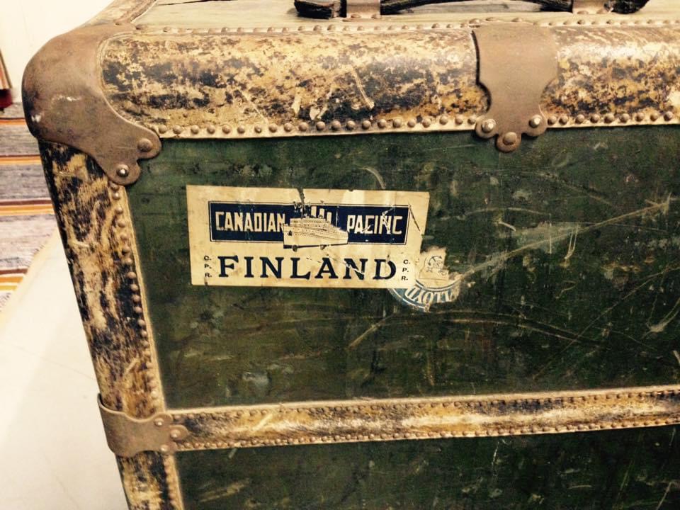 A piece of luggage with a Finland travel sticker on it