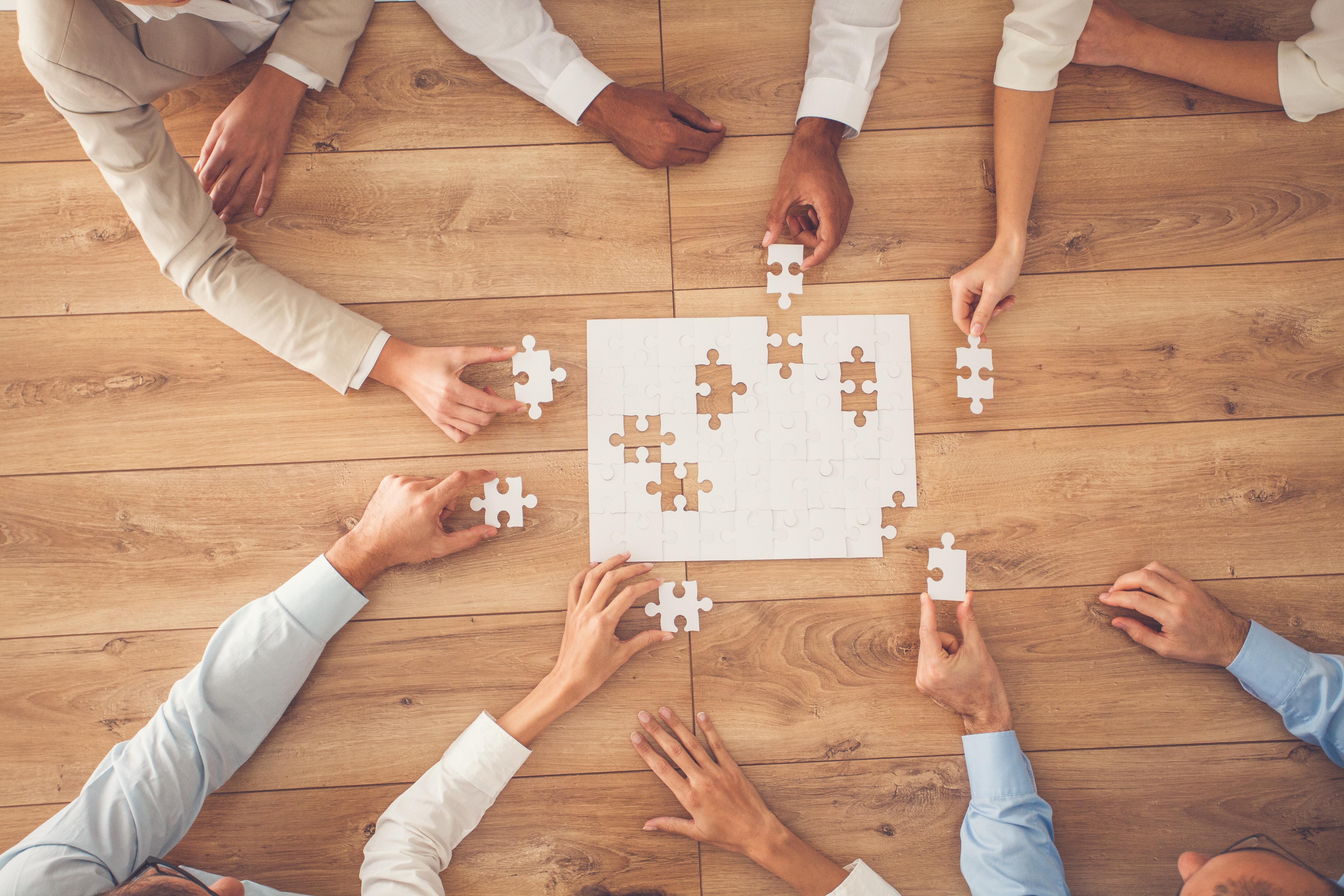 Hands working together on a puzzle