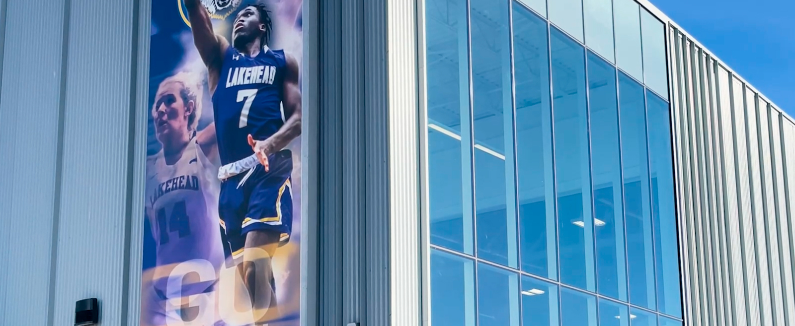 A photo of a banner featuring student athletes outside our training facility