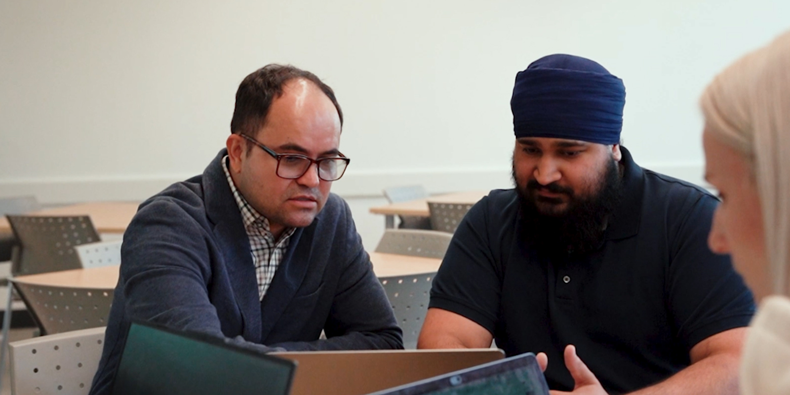 A professor assisting students debug their code.