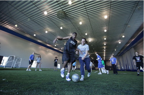 Lakehead University students playing soccer in the C.J Sanders Fieldhouse
