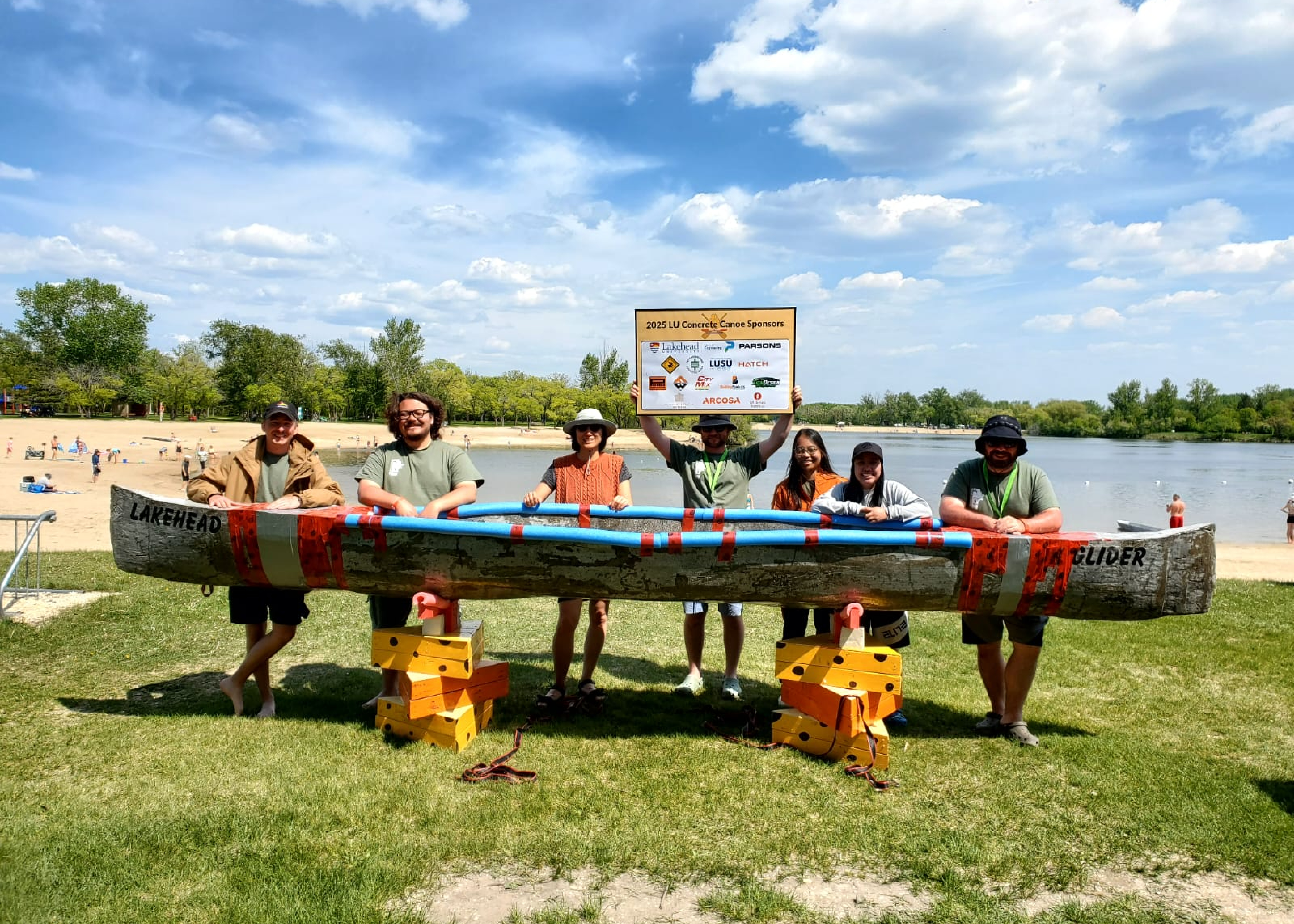 Student team with their concrete canoe in the water
