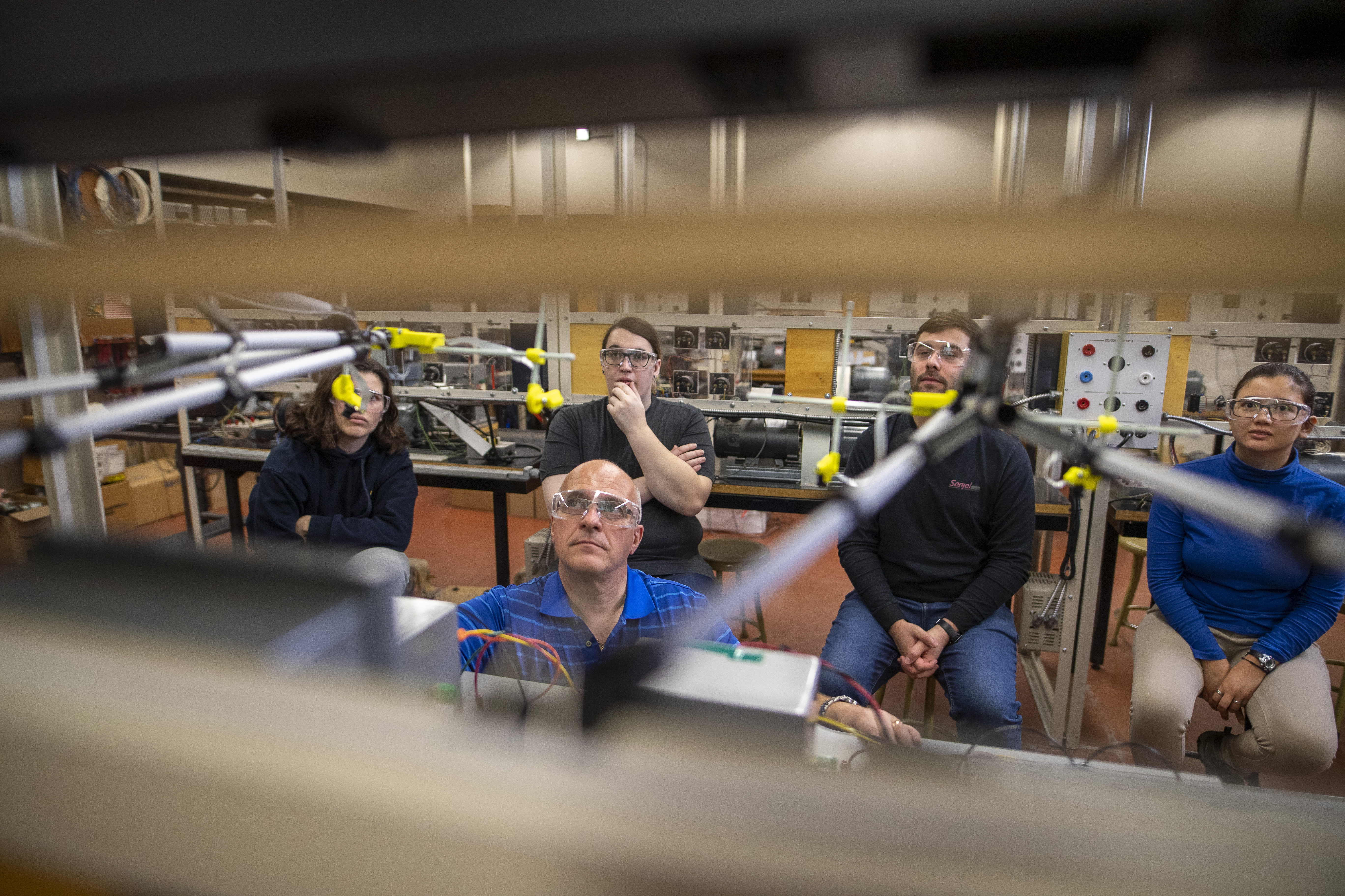 Electrical engineering students with instructor