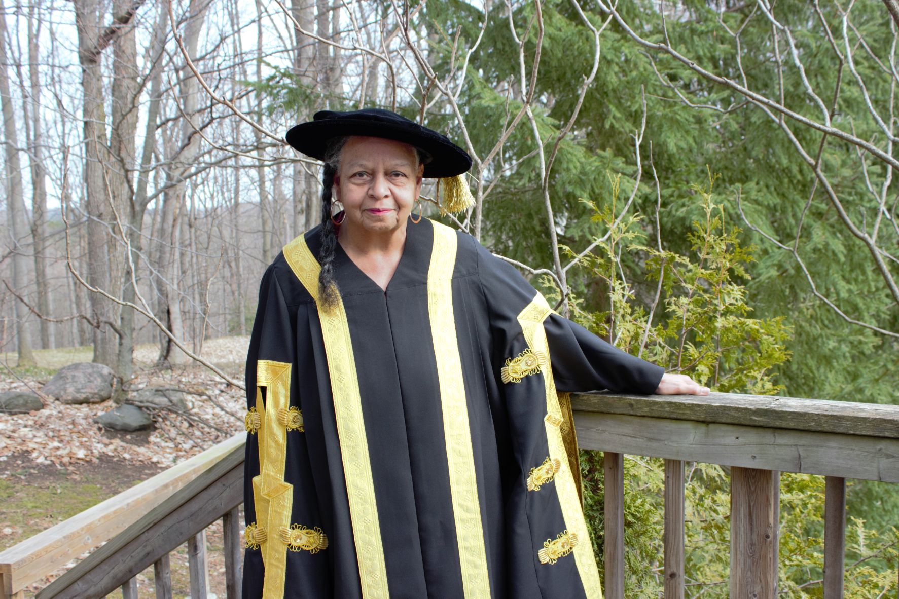 Lakehead Chancellor Rita Shelton Deverell wearing ceremonial robes on a deck outdoors