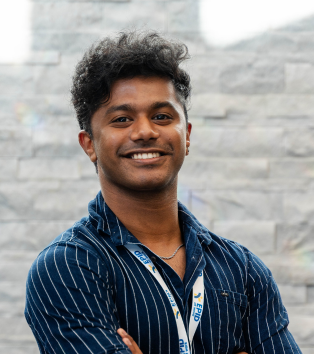 Portrait photo of Jerin, a man in business attire