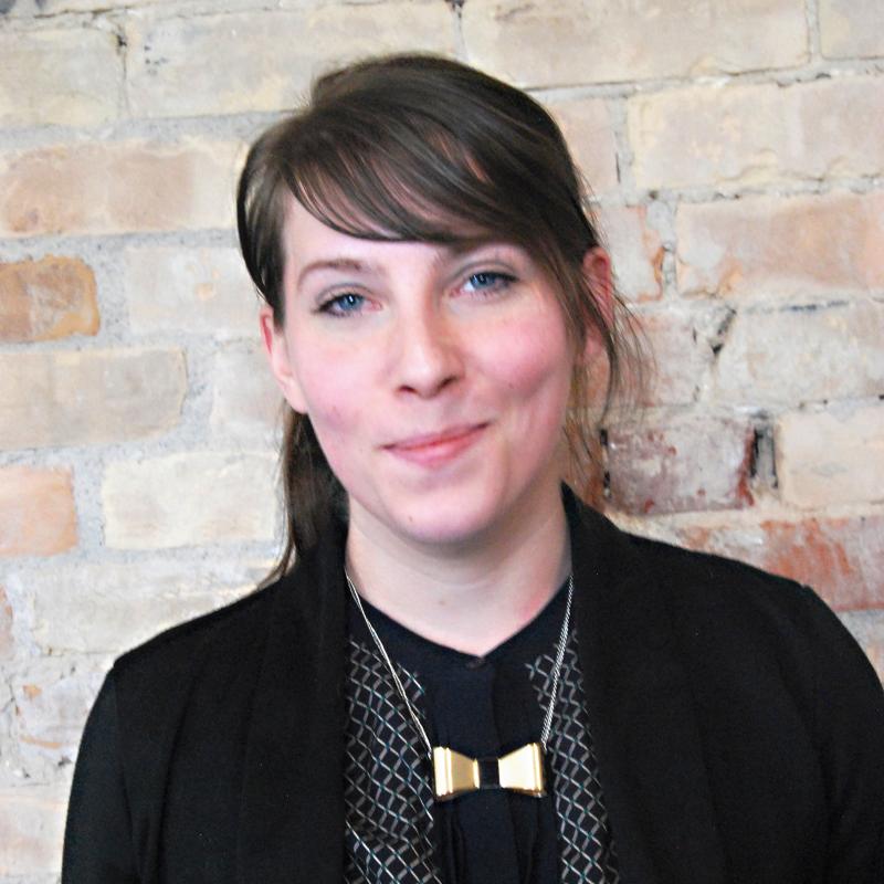 Photo of Jessica Gagnon, Marketing and Communications Associate in front of a brick wall