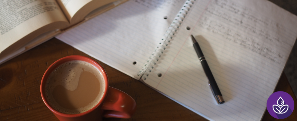 Note book, coffee cup and pen