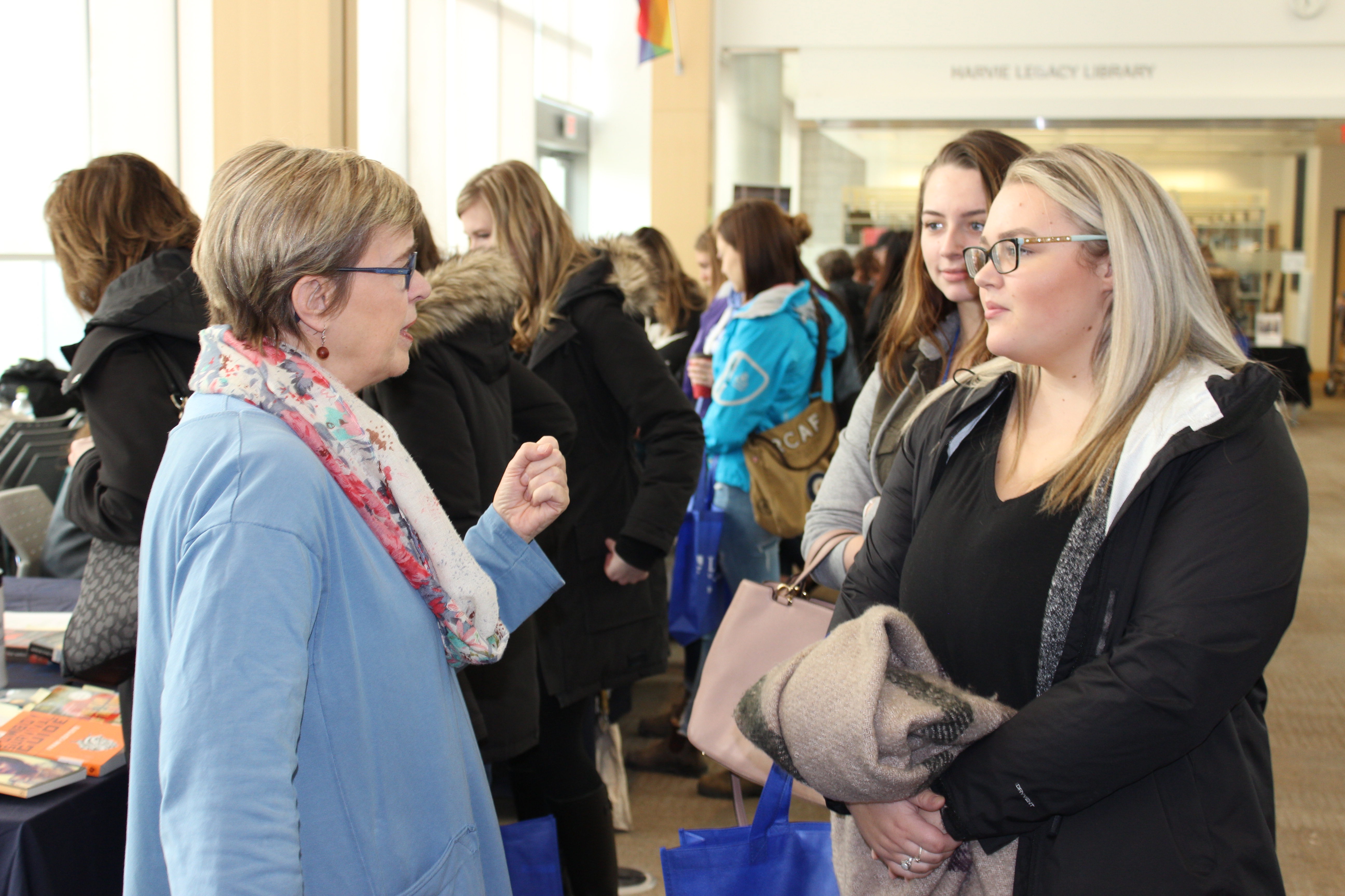 A future student speaks to Lakehead University faculty member during open house