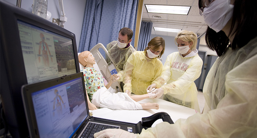 Nursing students work in simulation lab with pediatric patient