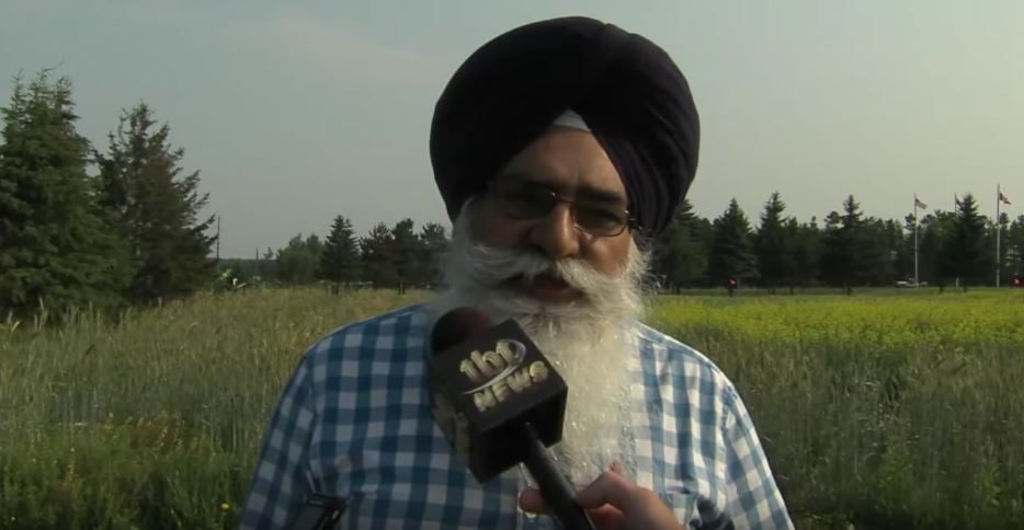 Dr. Tarlok Sahota being interviewed by tbt newswatch in one of the many fields of the agricultural research station